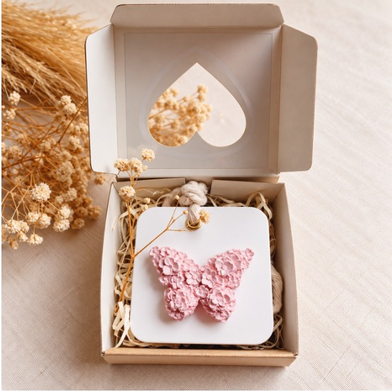 Piedra difusora de mariposa rosa en caja de presentación